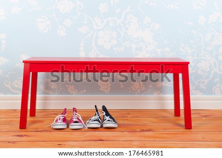Hall with blue vintage wall paper red bench on and wooden floor and shoes