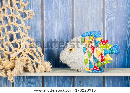 Stuffed Colorful Funny Fish At Home On Blue Wooden Background