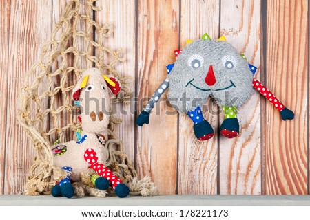 Stuffed colorful handmade funny toys at home on wooden background