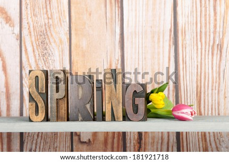 spring written with vintage used print letters and tulips