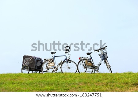 Female and male bike with dog car on the Dutch dike