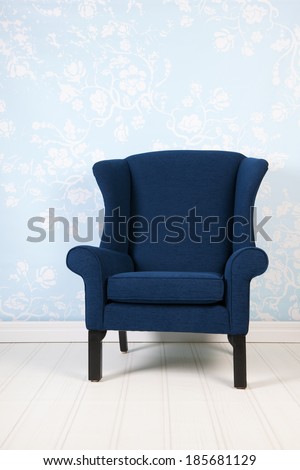Interior blue room with vintage wall paper and armchair