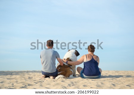 Owners with their big dog at the beach