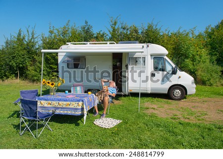 Senior man with dog and mobil home at campground