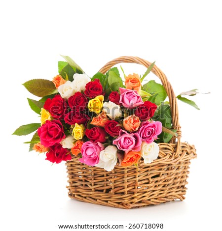 Bouquet colorful roses in wicker basket isolated over white background