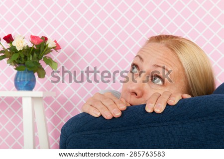 middle aged woman having fear in the living room
