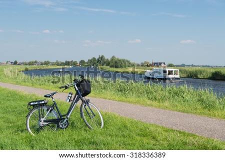 Typical Dutch landscape with river water and bike