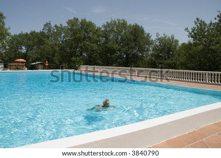 a swimming man in a luxury swimmingpool