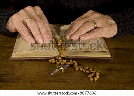 a pair of old hands while reading the old bible