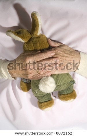 Old demented person with stuffed rabbit