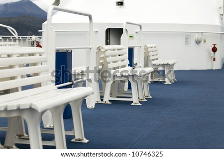 plastic benches at the deck of the boat