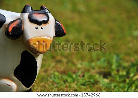 toy cow in the grass