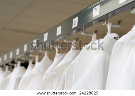 white coats at a row in a laboratory