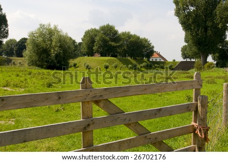 landscape with dike and dike-house near the river Waal