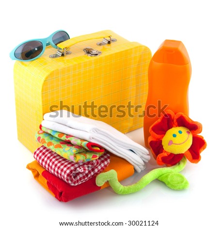 Packed suitcase with clothes and sun tanning