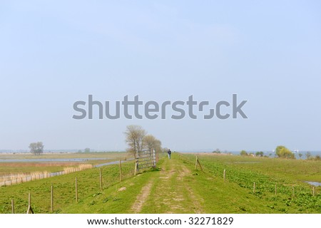 Water landscape in Holland with walking person