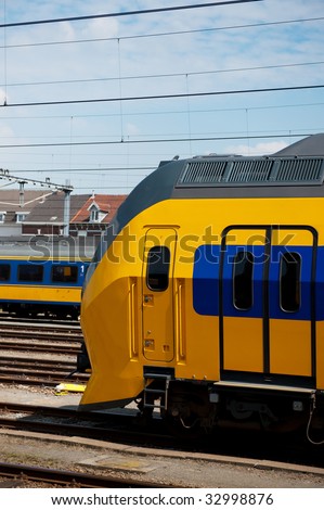 Yellow and blue train in Holland at the railway station