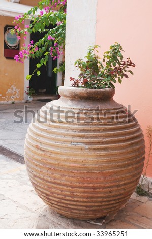Typical Greek vase with pink bougainvillaea flowers