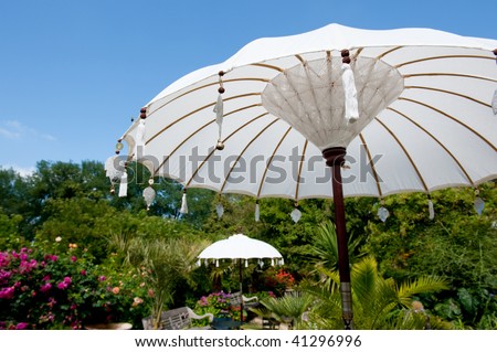 Asian summer garden with parasols for shadow