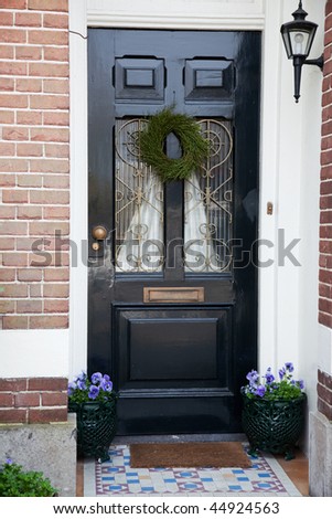 Dutch front door with flowers and lantern