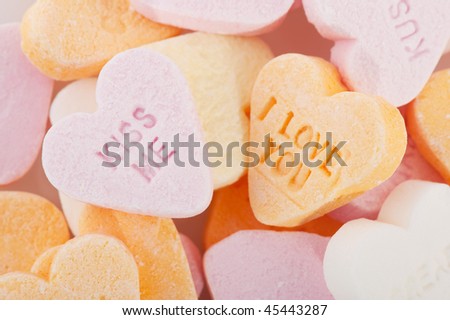 Many candy hearts with text and love you