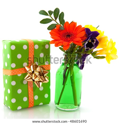 Cheerful birthday flowers and present over white
