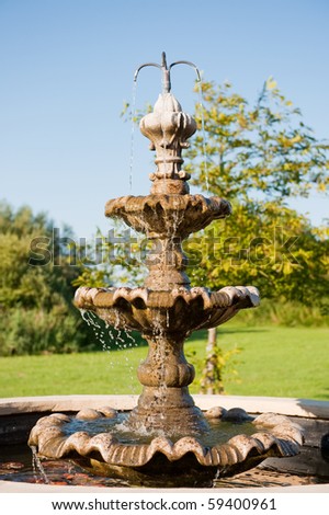 Spouting water fountain in nature environment at summer