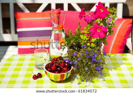 clear carafe with water and fresh fruit in the garden