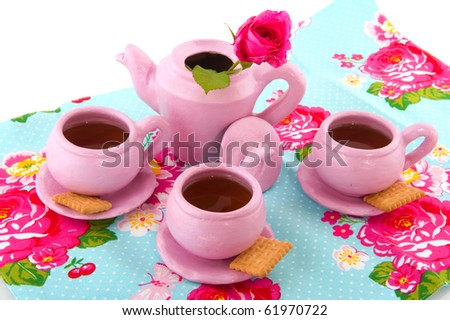 Pink hand craft service with cups of tea isolated over white