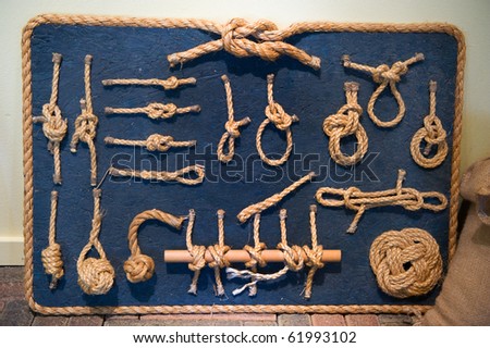 Many ship knots in natural rope on blue board
