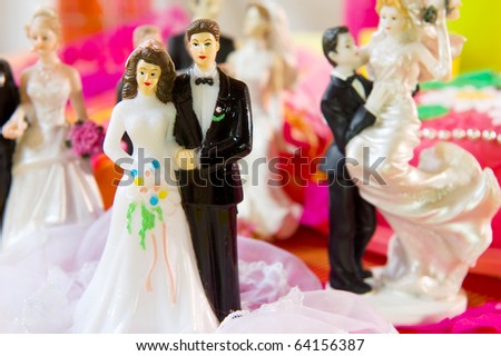Many Wedding couples in front of a cake in pink still life