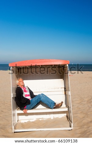 Man is sleeping in a classic beach chair