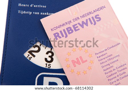 Dutch driver license and parking card on white background