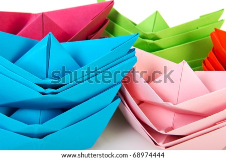 Colorful folded paper boats on white background