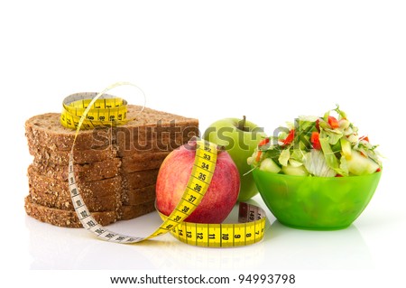 Healthy food for diet as bread fruit and vegetables with measurement tape