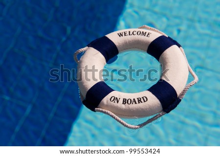 Life buoy floating in the two colored swimming pool in dark and light blue