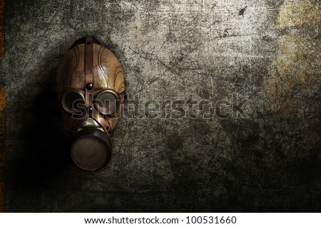 a gas mask hanging on a old concrete wall