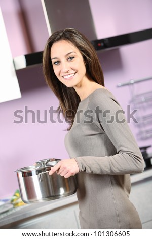 portrait of smiling young woman cooking