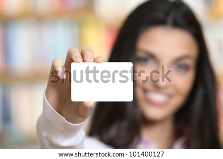 smiling young female showing a business card  -  copy space.