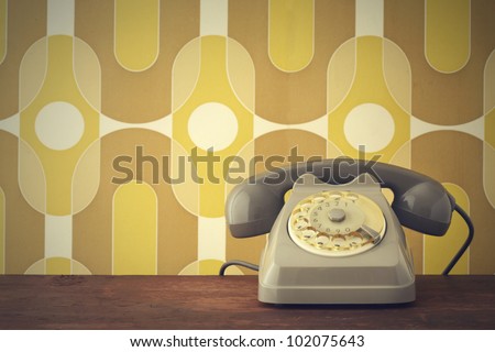 Old-fashioned phone on vintage background