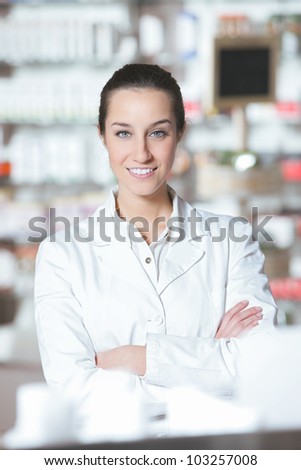 portrait of young health care worker and background pharmacy.
