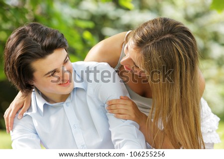 a young couple in love jokes and play in the park. close up.