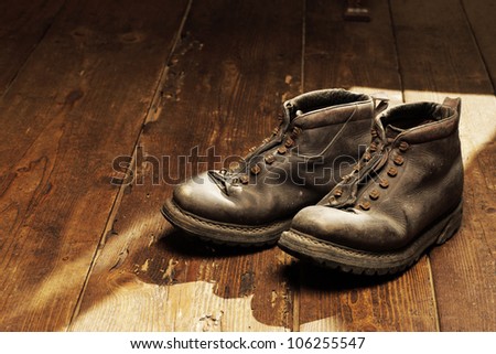 Old boots on the wooden floor, copy space