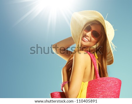 Smiling young woman against blue background, copy space
