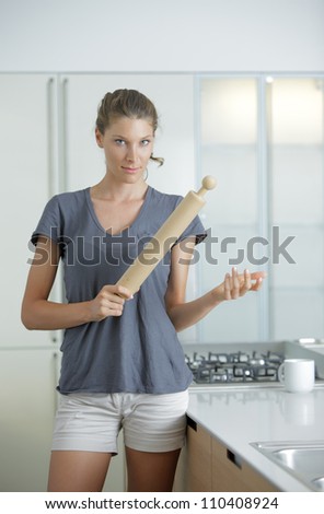 Angry housewife with rolling pin