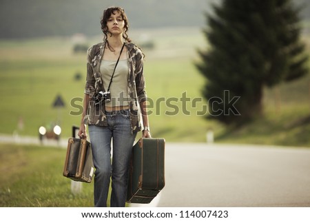 Young woman runaway walks away road