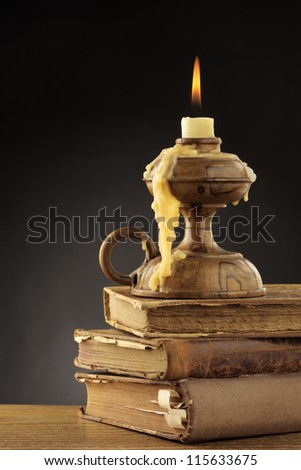 Old candle on dark background