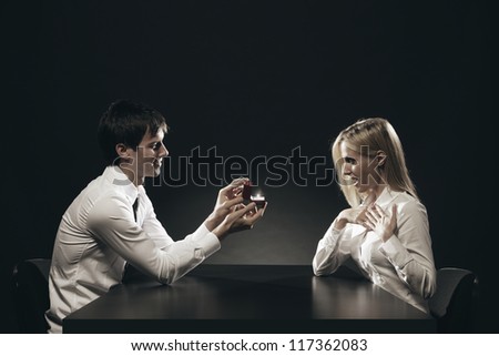 Young man proposing marriage to beautiful girl