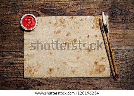 chinese brushes on wooden board, antique paper is a space for your text