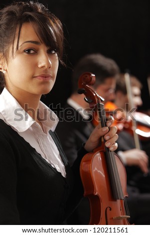 Classical music concert: Portrait of young woman violinist